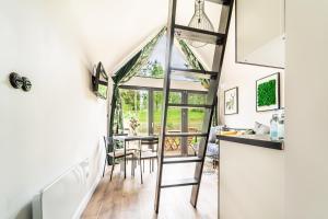 a kitchen and dining room with a ladder in a house at Gulbity Camp in Gulbity