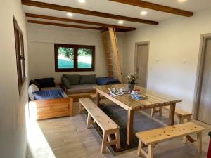 a living room with a table and a couch at Mountain Heart House in Bosanski Petrovac