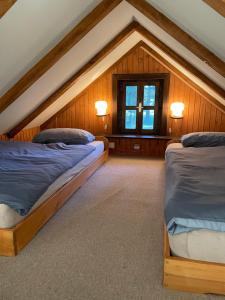 two beds in a room with a attic at Mountain Heart House in Bosanski Petrovac