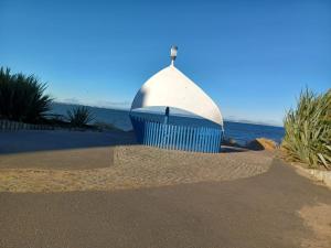 a structure on the beach with the ocean in the background at Riverside in Musselburgh