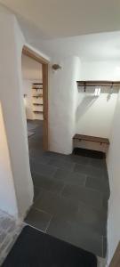 a room with a hallway with a tile floor at Apartment Slovan in Škofja Loka