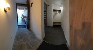 a hallway with a door and a room with a floor at Apartment Slovan in Škofja Loka