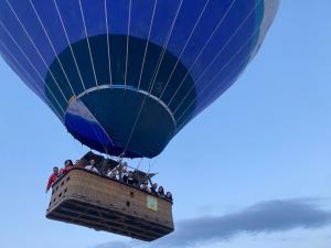 a blue hot air balloon flying in the sky at Ala Stone Hotel in Göreme