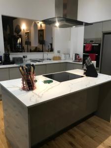 a kitchen with a white counter top in a room at Beautiful grade II listed 4 bed Victorian Conversion - Billericay Essex in Billericay