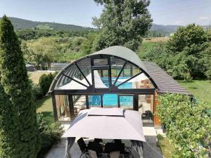an overhead view of a glass house with a pool at Deluxe Villa Coast River Sarajevo in Visoko