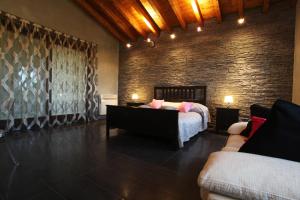 a bedroom with a bed and a brick wall at B&B Cascina Quaderna in Castenedolo