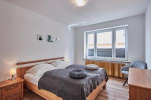 1 dormitorio con cama, escritorio y ventana en Apartamenty Świnoujście -Żeromskiego 5 en Świnoujście