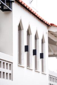 a row of windows on a white building at Plinthos Residence in Kavala