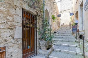 a stone building with a door and a potted plant at Lovely apartment in Saint-Paul-De-Vence in Saint Paul de Vence