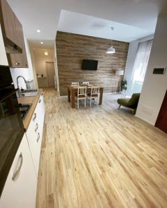 a kitchen and living room with a wooden floor at Plebiscito House in Castel di Sangro