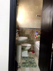 a bathroom with a sink and a toilet at porto marina panoramica sea view in El Alamein