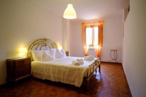 a bedroom with a bed with towels on it at Dimore Tarantini in Polignano a Mare