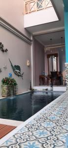 a house with a swimming pool in a room at Most Bali Malioboro Villa in Yogyakarta
