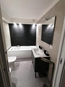 a bathroom with a sink and a tub and a toilet at La Casa di Orlando in Catania +33 photos