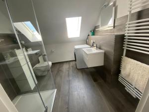 a bathroom with a toilet and a sink at Pension Eckert in Zwenkau +24 photos