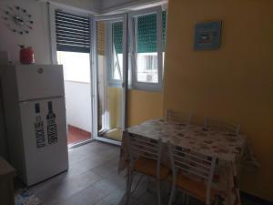 a dining room with a table and a refrigerator at NICOLHOME in Rome