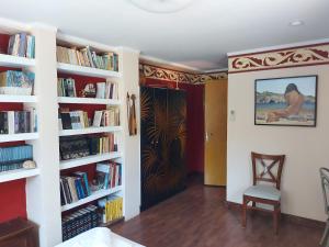 a room with white shelves filled with books at Varias Art House in Kallirákhi