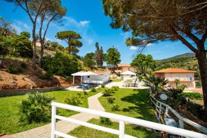 a view of the garden from the balcony of a house at Residence Reale in Porto Azzurro