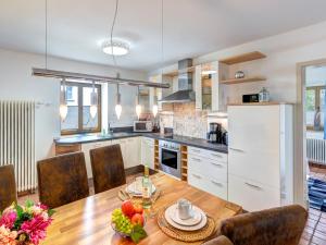 a kitchen with a table and a dining room at FeWo Tusculum in Zinnowitz