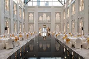 a banquet hall with white tables and white chairs at Arjaan by Rotana - Dubai Media City in Dubai +76 photos
