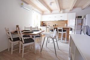 a kitchen with a table and chairs in a room at Husovka No135 in Libice nad Cidlinou