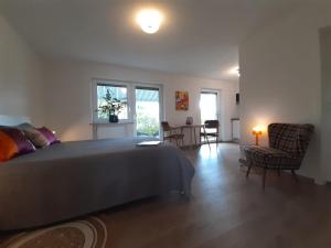 a bedroom with a bed and a table and chairs at Stilvolles Studio im Allgäu in Rettenbach am Auerberg