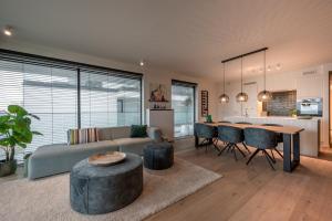 a living room with a couch and a table at Green h(e)aven in Nieuwpoort