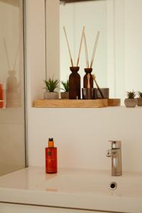 a bathroom sink with a red container on the counter at Loft-Apartment - Bestlage am Kurpark mit Terrasse - kostenloses Parken - Küche - Netflix - Waschmaschine in Wiesbaden +66 photos