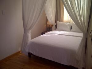 Postel nebo postele na pokoji v ubytování Anh Dao Mekong Hotel