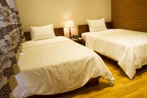 Postel nebo postele na pokoji v ubytování Anh Dao Mekong Hotel