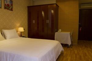 Postel nebo postele na pokoji v ubytování Anh Dao Mekong Hotel