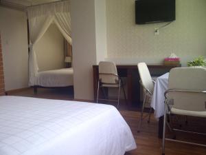 Postel nebo postele na pokoji v ubytování Anh Dao Mekong Hotel