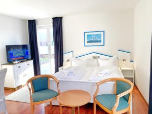TV a/nebo společenská místnost v ubytování Hafenresidenz - Ferienwohnung 31 + 5 fotografií