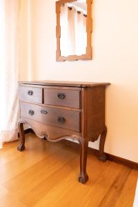 a dresser with a mirror on top of it at Bragança Apartments in Bragança