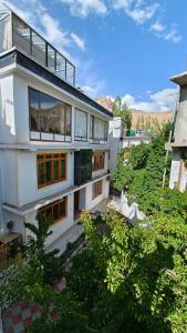 an aerial view of a white building with trees at Serdung Guest House in Leh