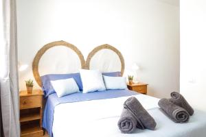 a bedroom with a large bed with towels on it at Casa Nadia in Corralejo