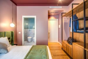 a bedroom with a bed and a bathroom at Sheva Boutique Hotel in Milan