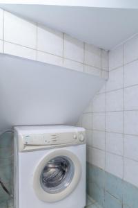 a washer and dryer in a small bathroom at Cozy Loft near Downtown in Heraklio