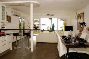 a kitchen and living room with a table and chairs at Elegant Horizons in Ko Chang