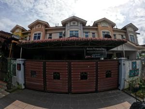 a house with a wooden gate in front of it at Aurura PremiumStay Exclusive Home in Johor Bahru