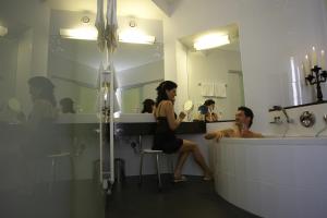 a man and a woman sitting in a bathroom at Hotel Weißes Kreuz in Bregenz