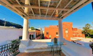 阿纳卡普里Piazza La Torre的阳台配有桌子,享有建筑的景致。