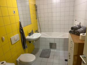 a bathroom with a sink and a toilet and a tub at House Marin II - Apartment in Maribor