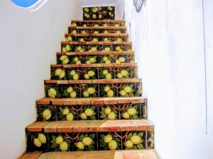 a staircase with green apples on it at Piazza La Torre in Anacapri