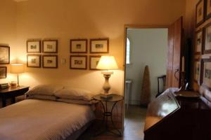 a bedroom with a bed and a lamp and pictures on the wall at The Engine House in East Dereham