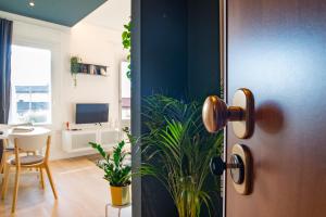 a door leading into a living room with a dining room at BR Treviso Train Station Apartments in Treviso
