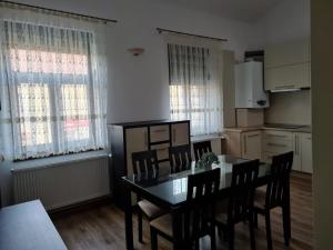 a kitchen and dining room with a table and chairs at Apartament La Cetate in Aiud