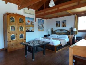 a bedroom with a bed and a table in it at Varias Art House in Kallirákhi