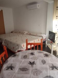 um quarto com uma cama e uma mesa com um cobertor em Estudio Plazamar em Torre del Mar