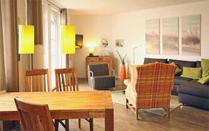 a living room with a couch and a table at Haus Meeresblick - Ferienwohnung Strandburg B 1.02 (Ref. 136069) in Baabe